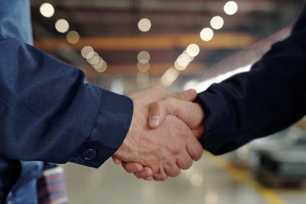 Handshake between factory executives